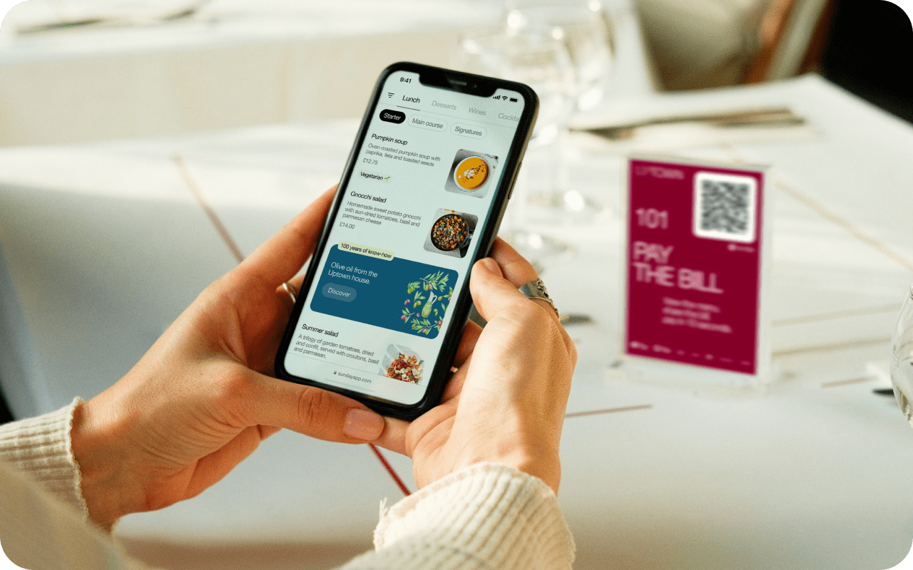 Customer using a smartphone to view a digital restaurant menu via QR code with the Scan2Order system.
